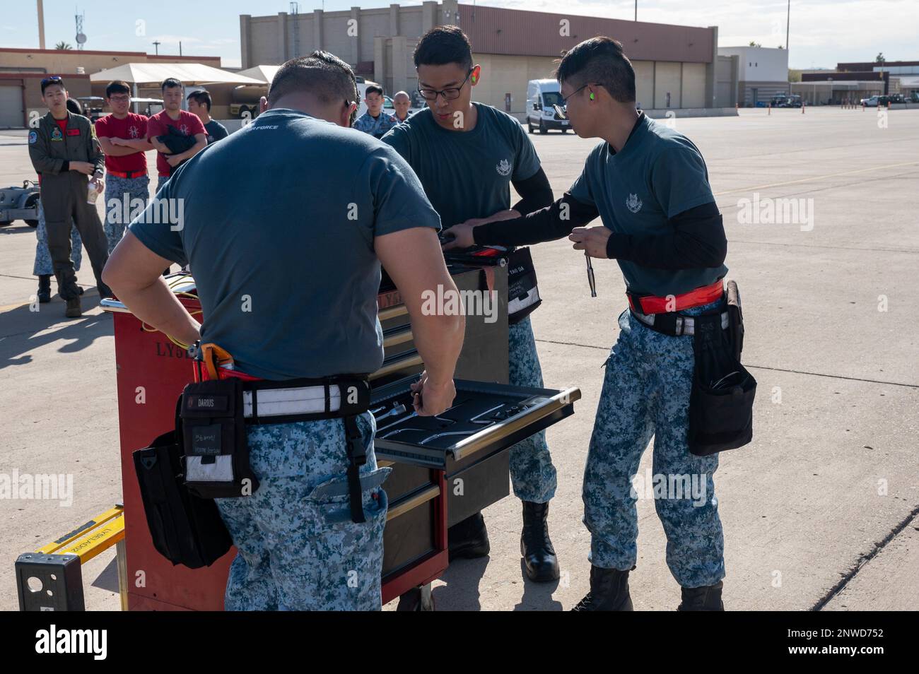 Singaporean air force ME2 Darius Lee, ME1 Wong Boon Soon and ME1 Lim Yao Da, 425th Aircraft Maintenance Unit maintainers, organize their crew toolbox during the annual weapons load competition Feb. 3, 2023, at Luke Air Force Base, Arizona. Load competitions are used in place of written evaluations when determining quarterly and annual award winners for the weapons career field. Stock Photo