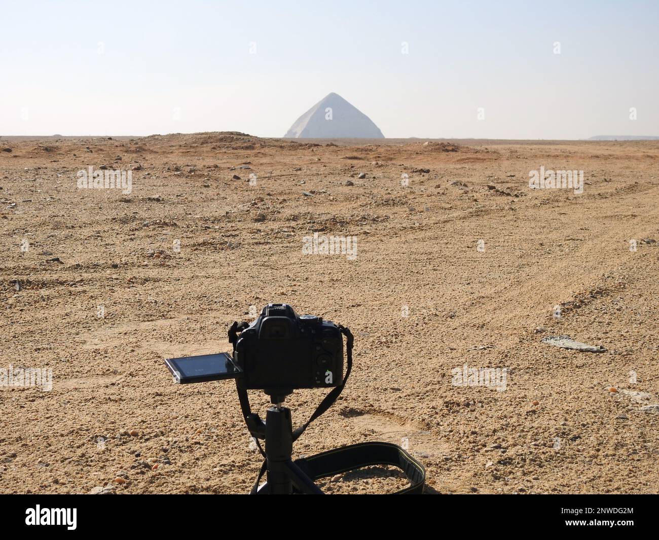 A digital DSLR camera on a tripod Photographing the Bent Pyramid of