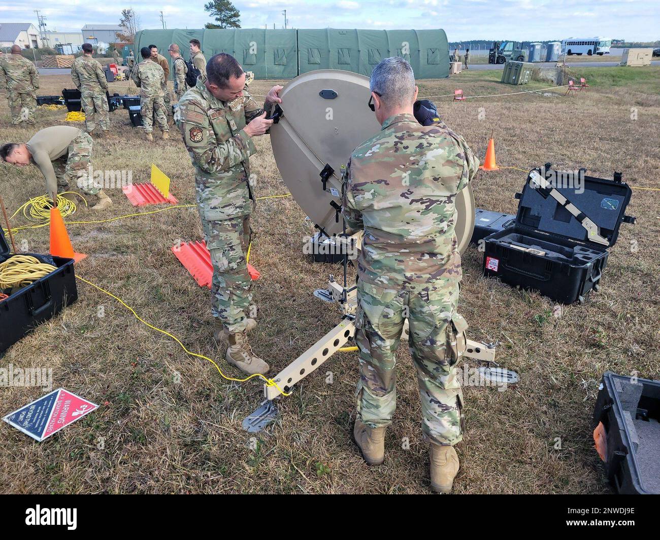 Members of the 263rd Combat Communications Squadron set up antenna and run cables for the Communications Flyaway Kit (CFK) at Marine Corps Air Station Cherry Point, N.C., Dec. 14, 2022. These efforts are in support of the 4th Fighter Wing Operations Center. Stock Photo