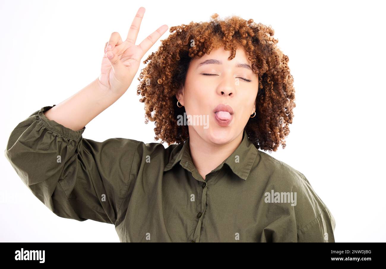 Fun, happy and peace sign by woman posing tongue out and closed eyes ...