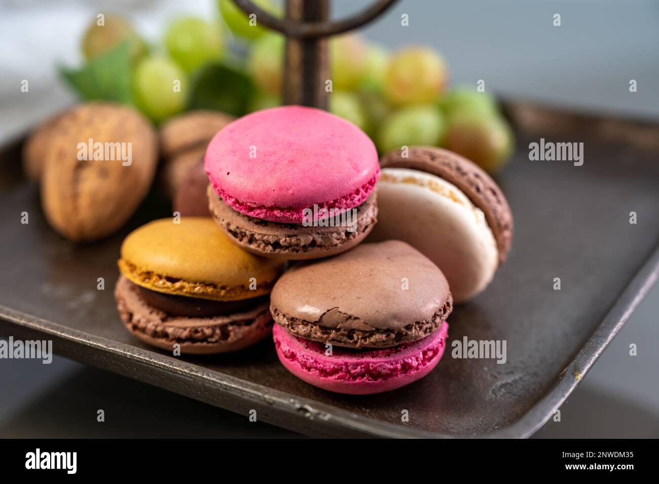 Macarons or French macaroon  sweet meringue-based confection made with egg white, icing sugar, granulated sugar, almond meal, and food colouring, swee Stock Photo