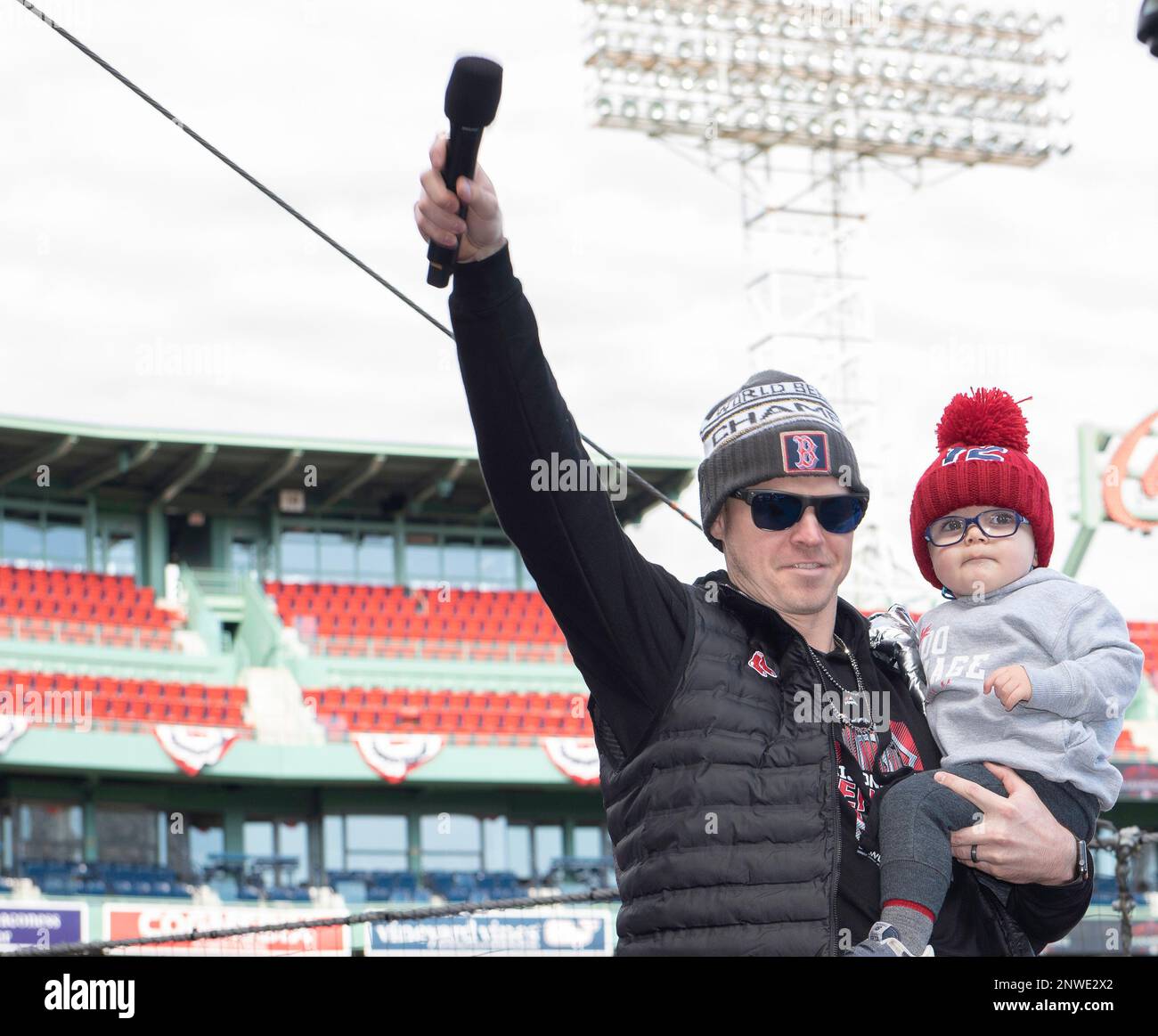 Boston Red Sox's Brock Holt reaches for his son Griffin as he arrives back  in Boston with his family, Monday, Oct. 29, 2018. The Red Sox defeated the  Los Angeles Dodgers on