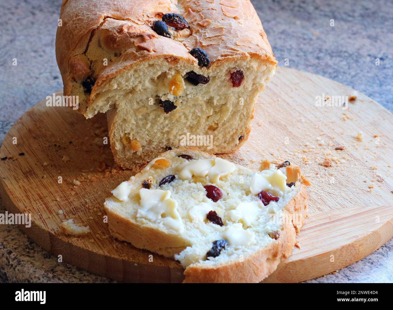 Home made fruit loaf. A piece cut and buttered. Stock Photo