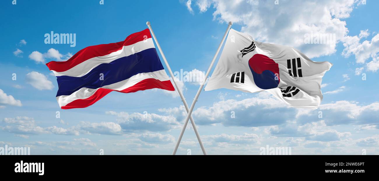 two crossed flags south korea and Thailand waving in wind at cloudy sky ...