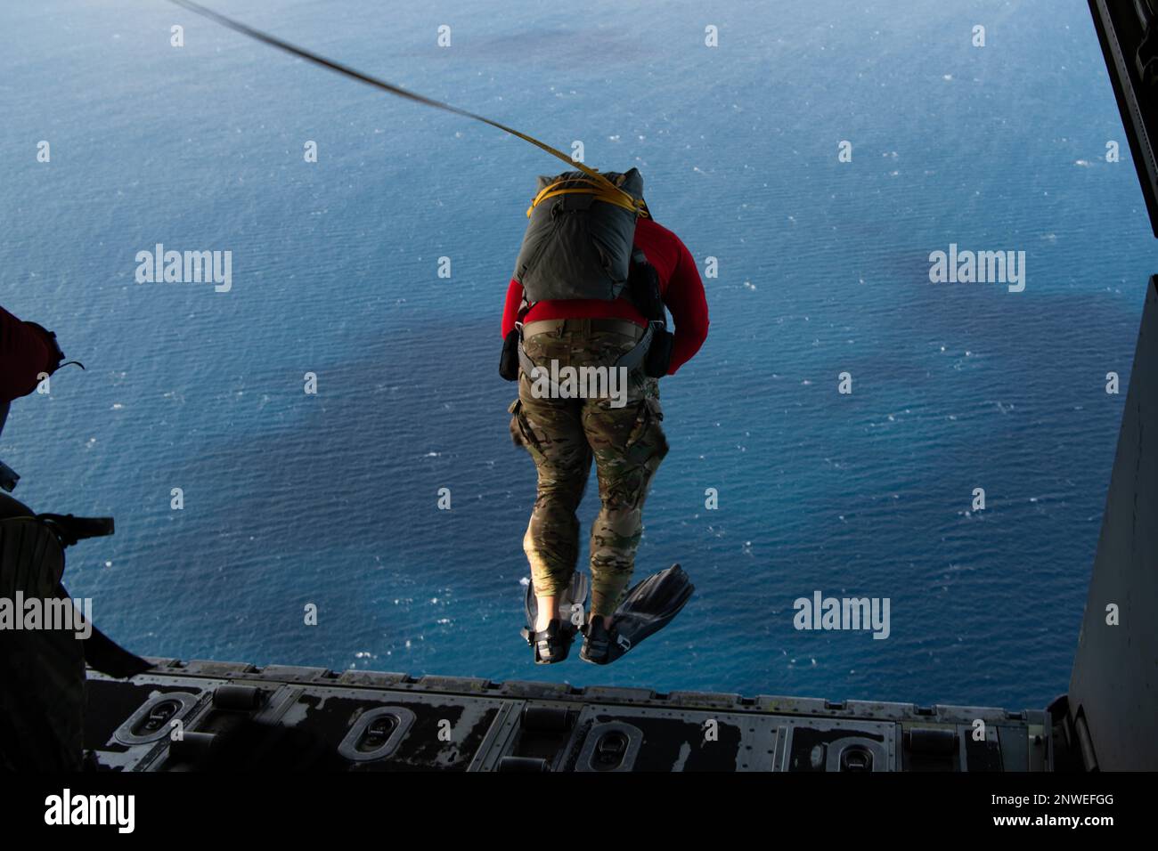 A U.S. Air Force 31st Rescue Squadron pararescueman jumps out of a 1st Special Operations Squadron MC-130J Commando II, over the Pacific Ocean, Feb. 22, 2023. Pararescuemen train rigorously and meticulously to ensure that when they are called, every member of the team can perform with precision. Stock Photo