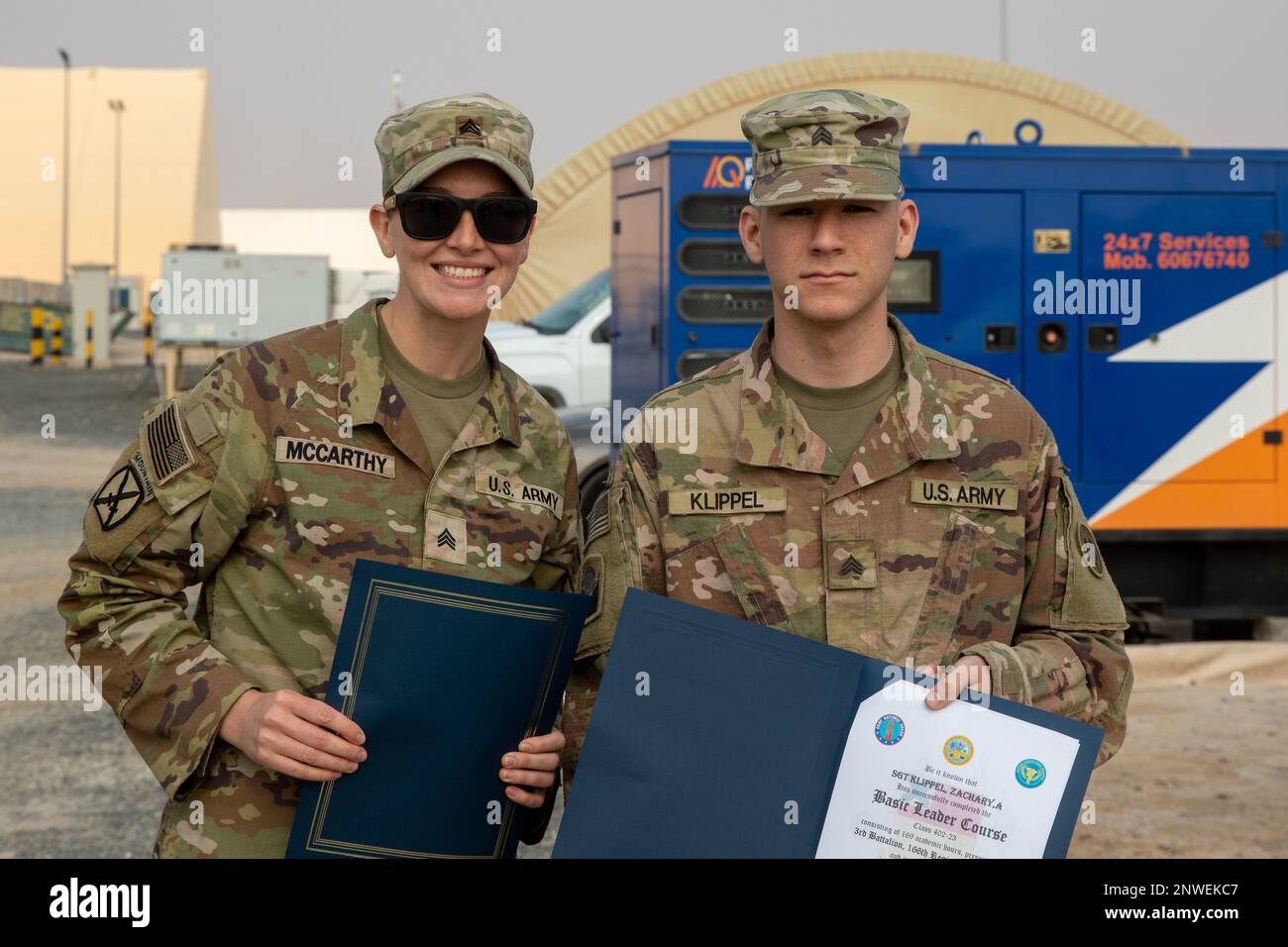 U.S. Army Sgt. Michelle McCarthy poses outside for picture with Sgt. Zachary Klippel after a BLC graduation ceremony held in a theatre tent on Camp Buehring, Kuwait, Jan. 25, 2023. Stock Photo