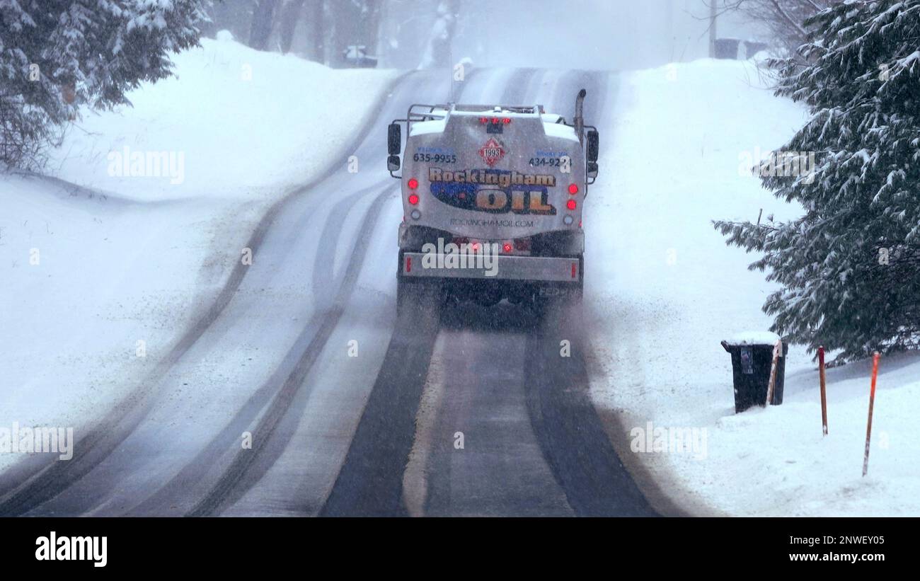 A home heating oil delivery truck climbs a snow covered road, Tuesday