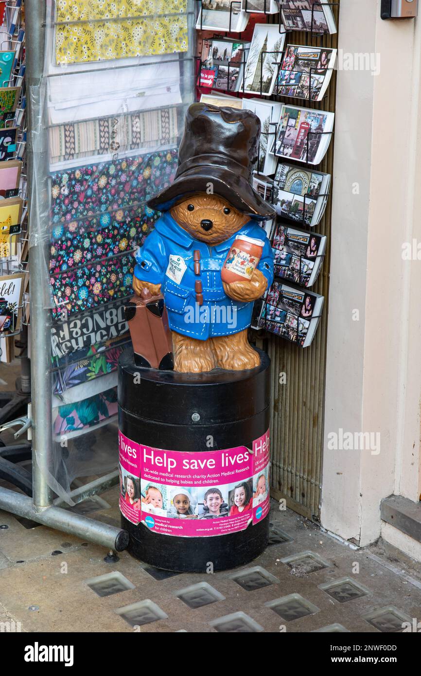 Paddington Bear money collection box of Action Medical Research for Children in front of a tourist shop in Notting Hill district of London, England Stock Photo