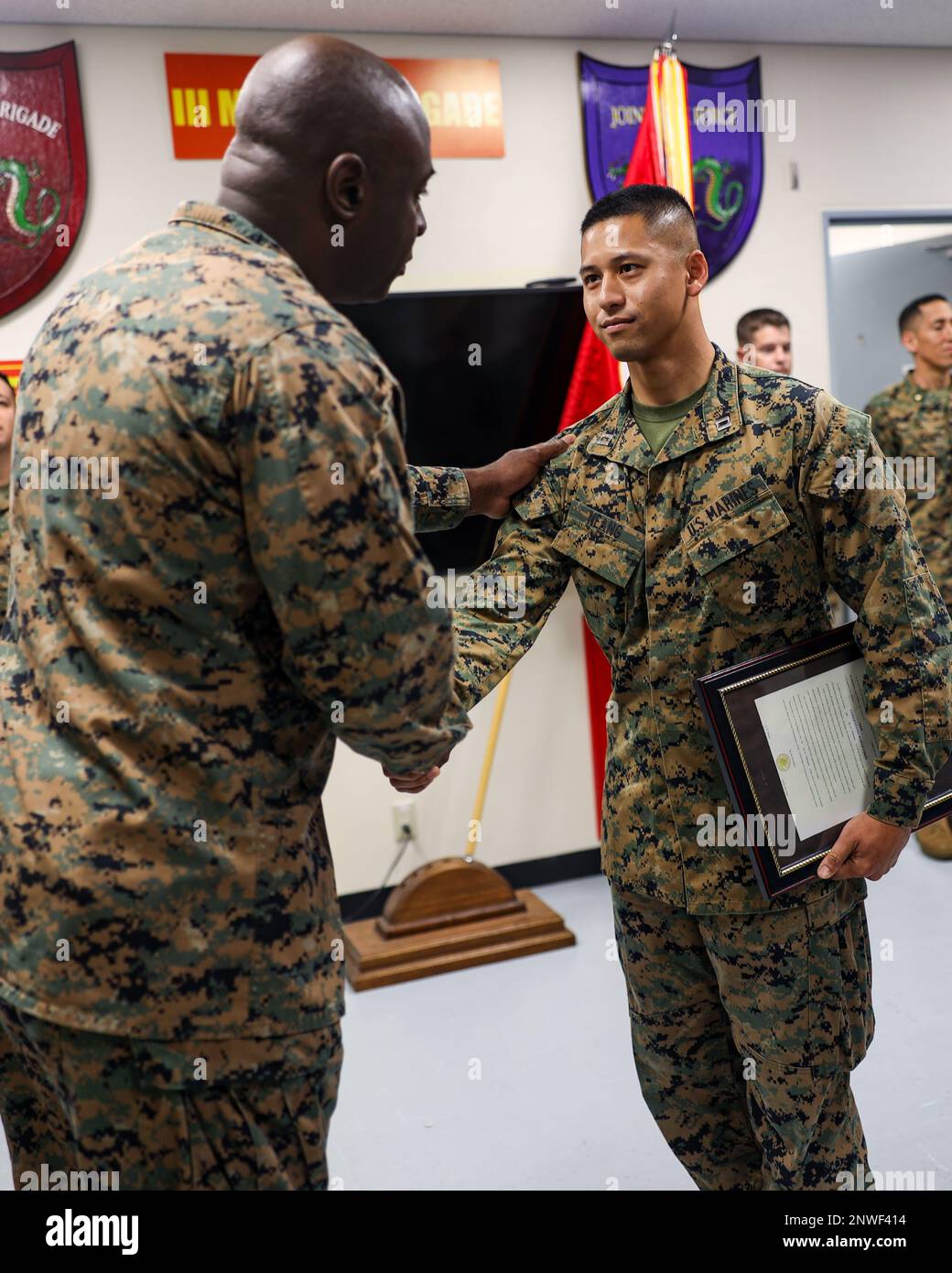 U.S. Marine Capt. Naro Neang, a military police officer with 3rd Marine Expeditionary Brigade, III Marine Expeditionary Force, is congratulated by Maj. Jeff Adusei, current operations officer, 3rd MEB, at Neang's promotion ceremony aboard Camp Courtney, Okinawa, Japan, Feb. 6, 2023. Neang, a native of Modesto, Calif., was commissioned as an officer in the Marine Corps on July 28, 2018, and reported to 3rd MEB on May 5, 2022. He currently serves as the anti-terrorism and force protection officer. Stock Photo