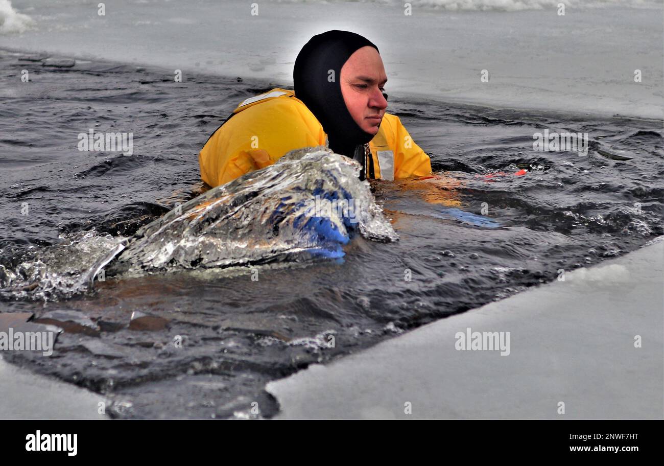 A firefighter wearing a cold-water immersion protective suit acts as a ...