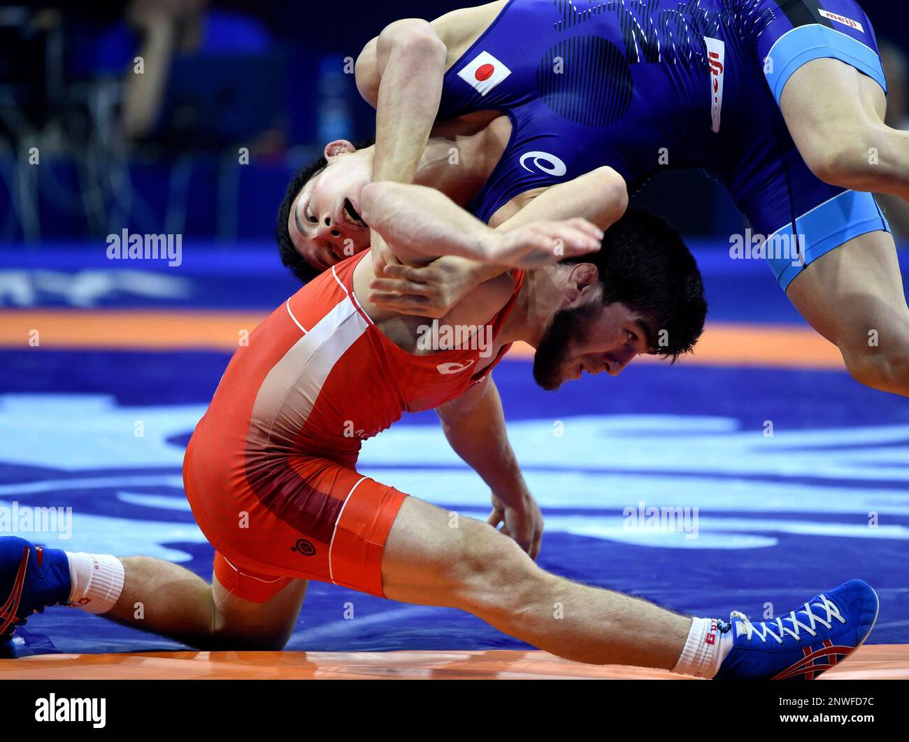 Yuki Takahashi, blue, of Japan and Zavur Uguev of Russia fight in the semifinal of mens freestyle 57 kg category of Wrestling World Championships in Papp Laszlo Budapest Sports Arena in Budapest,