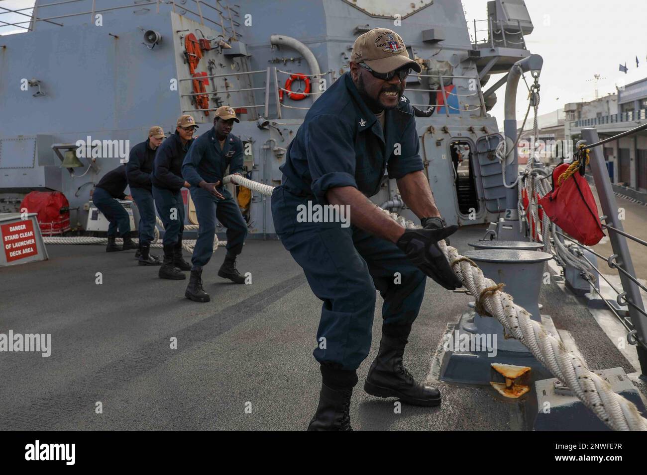 230129-N-JO162-1030 HAIFA, Israel (Jan. 29, 2023) Sailors assigned to the guided-missile destroyer USS Truxtun (DDG 103) heave line aboard as the ship pulls out of Haifa, Israel, Jan. 29, 2023. Truxtun is deployed to the U.S. 5th Fleet area of operations to help ensure maritime security and stability in the Middle East region. Stock Photo