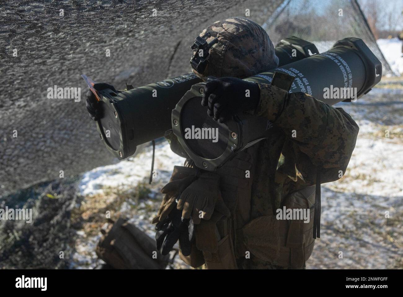 A U.S. Marine with 3d Battalion, 12th Marines carries propellants for an M777 towed 155 mm howitzer while conducting live-fire training during Artillery Relocation Training Program 22.4 at the Yausubetsu Maneuver Area, Hokkaido, Japan, Jan. 28, 2023. The skills developed at ARTP increase the proficiency and readiness of the only permanently forward-deployed artillery unit in the Marine Corps, enabling them to provide precision indirect fires. Stock Photo