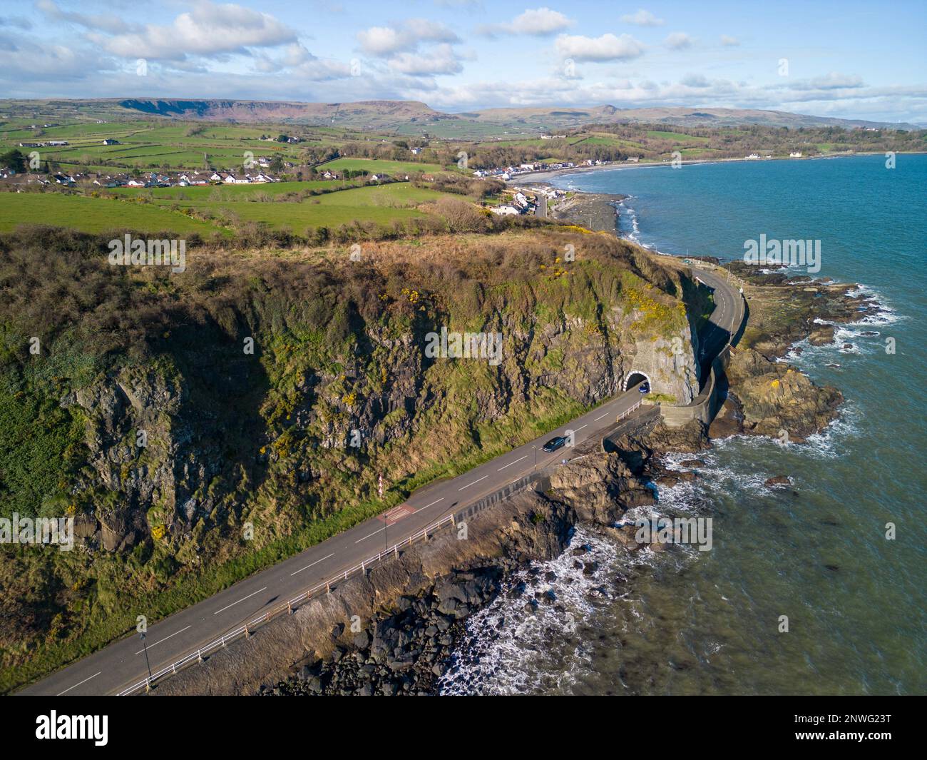 Aerial images of from various locations in and around Larne, County Antrim, Northern Ireland. In this photo, this is the  A2 causeway coastal route coast road which passes through the black arch blackcave tunnel as you leave Larne heading further North. Stock Photo