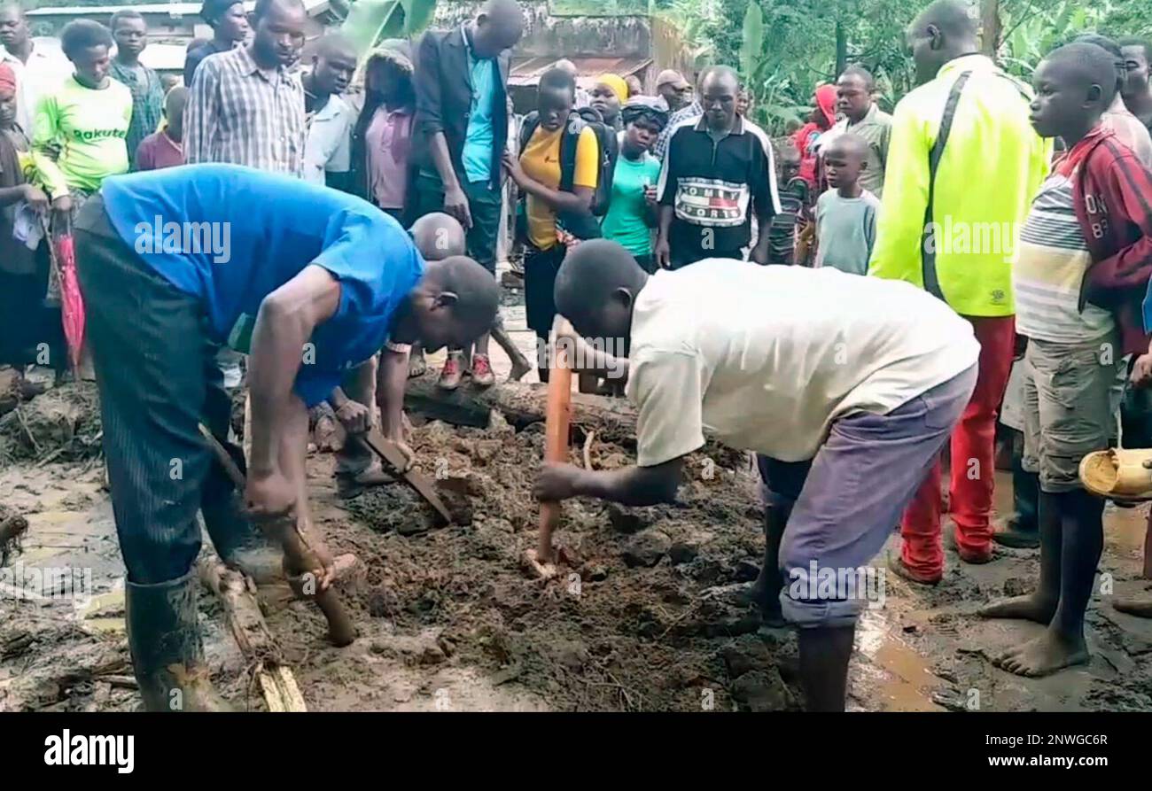 In this image made from video, residents dig in the mud in Bududa District,  Uganda, Friday, Oct. 12, 2018. At least 30 people died in mudslides  triggered by torrential rains in a