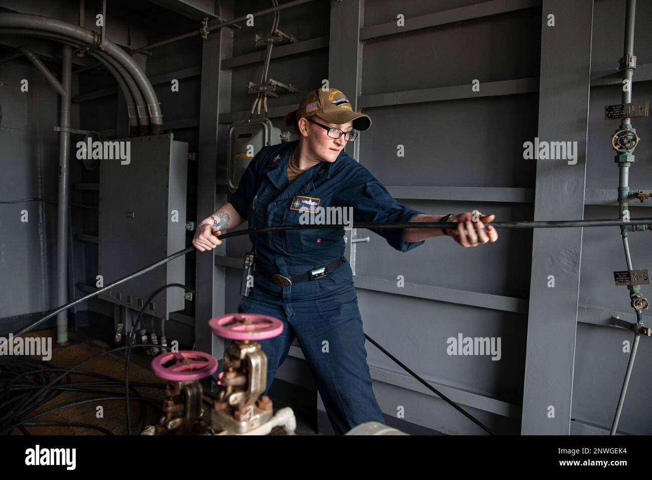 230208-N-XQ548-1068:  Interior Communications Electrician 2nd Class Felicia O’Lay, from Bradford, Pennsylvania, assigned to the first-in-class aircraft carrier USS Gerald R. Ford (CVN 78), pulls up the shore cable during sea-and-anchor detail, Feb. 8, 2023. Ford is underway in the Atlantic Ocean conducting carrier qualifications. Stock Photo