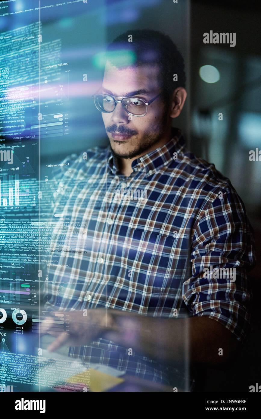 He writes in many programming languages. Cropped shot of a young computer programmer looking through data. Stock Photo
