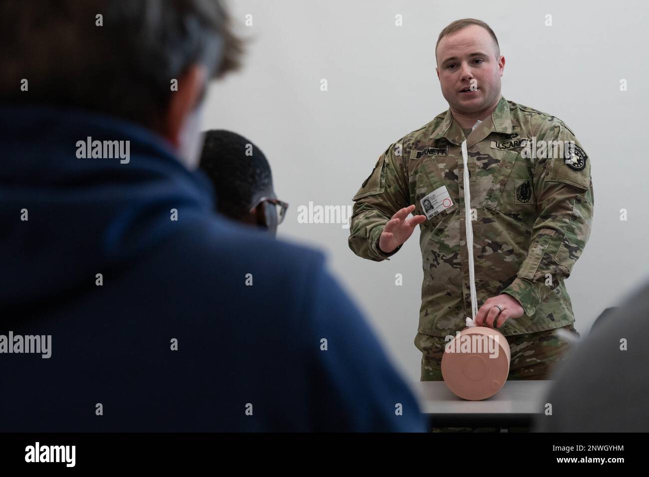 Staff Sgt. William Barnett, a combat medic specialist working as a recruiter in York, Pennsylvania, shows students in teacher Rick Guinan's applied sports medicine class at Central York High School how to pack gauze into a wound as part of the 'Stop the Bleed' program February 2, 2023. Guinan invited Barnett to assist with the program, which teaches people how to control bleeding in emergency situations. The partnership created an opportunity to expose students to careers and benefits available in the U.S. Army. Stock Photo