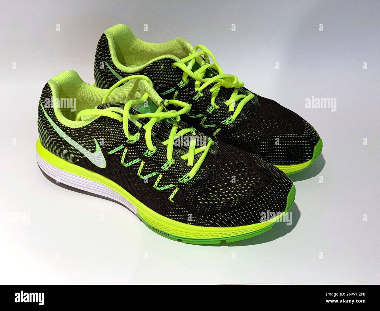 Detailed view of Nike Air Zoom Vomero 10 running shoes in volt/white, black  and electric green colorway. The shoes feature Flywire technology, mesh  fabric and Zoom Air units. (Kirby Lee via AP