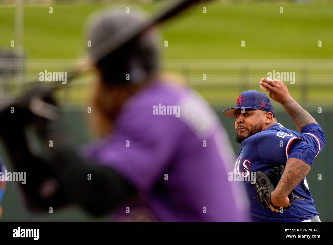 Texas Rangers pitcher Reyes Moronta throws to Colorado Rockies' Charlie