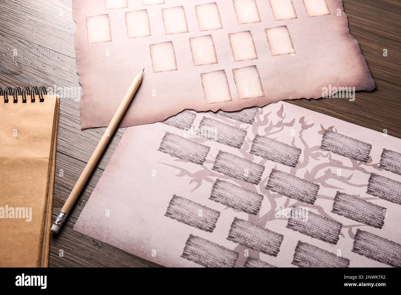 Blank family tree, notebook and pencil on wooden table, flat lay