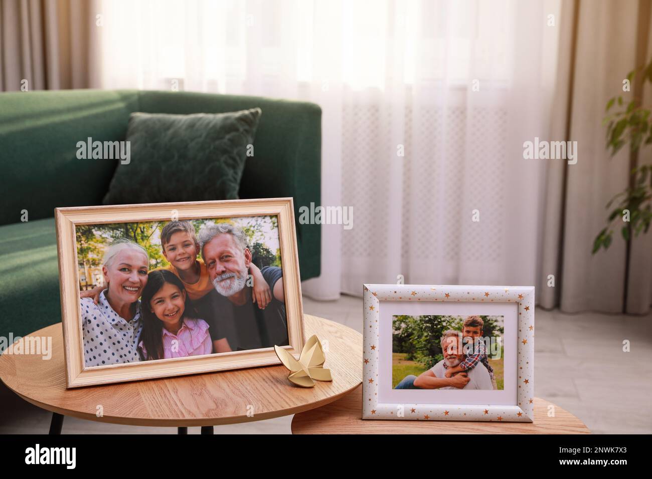 Framed family portraits in living room at home Stock Photo