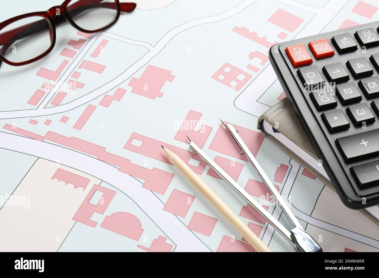 Office stationery and eyeglasses on cadastral map of territory with buildings Stock Photo