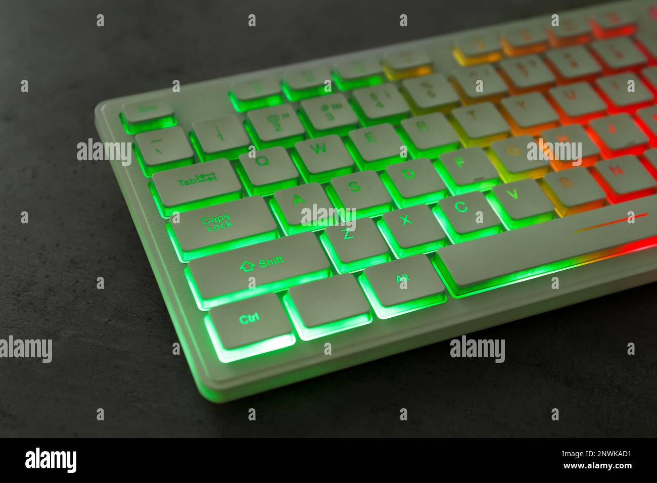 Modern keyboard with RGB lighting on grey table, closeup Stock Photo