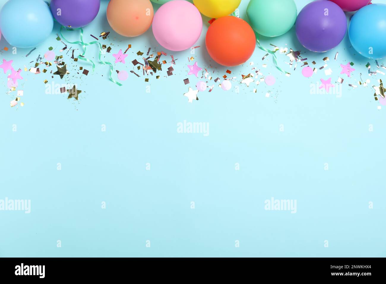 Party background with balloons, streamers and confetti on pastel blue  background. Birthday party decoration Stock Photo - Alamy