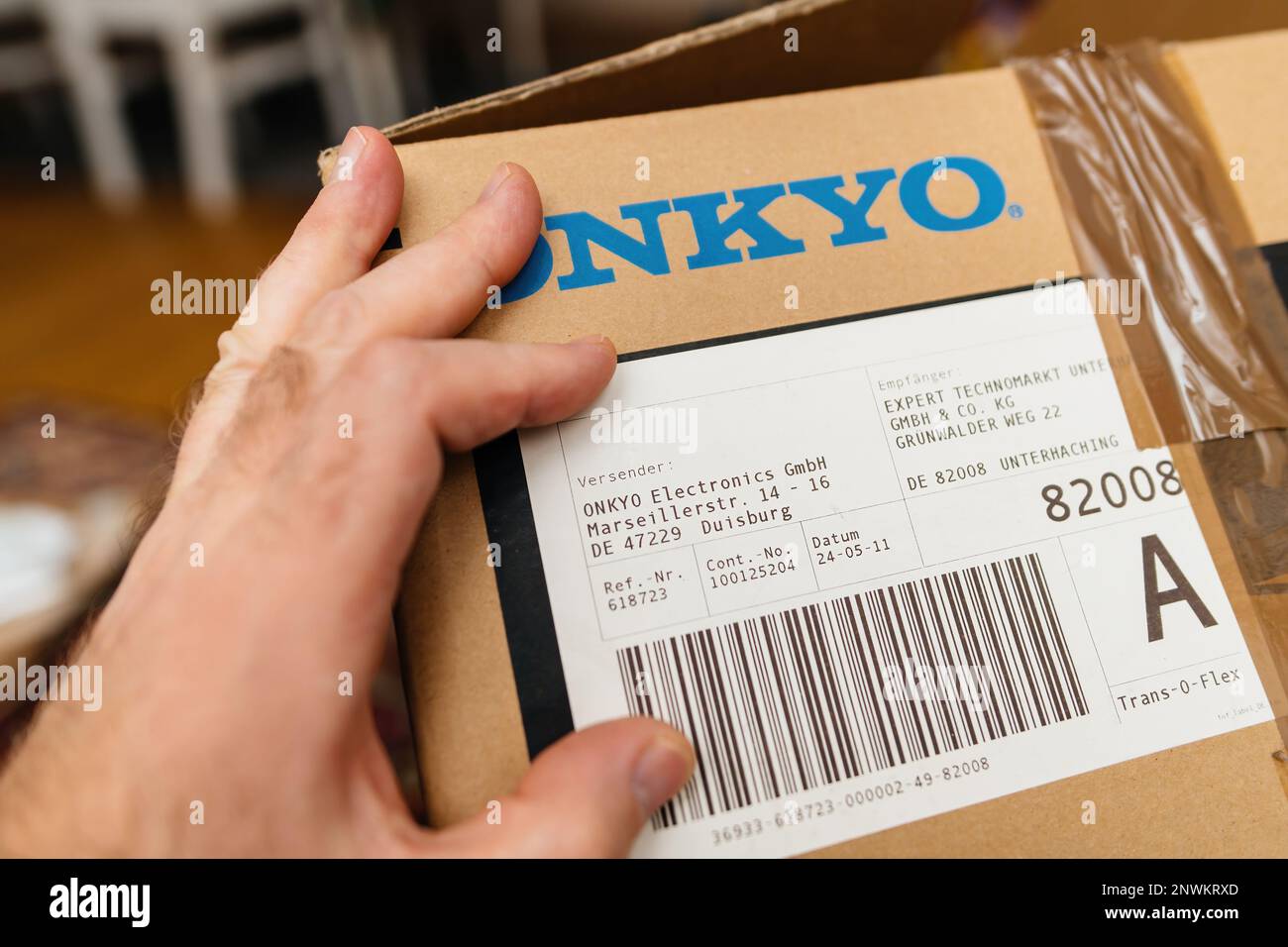 Frankfurt, Germany Feb 23, 2023 POV male hand holding new Onkyo