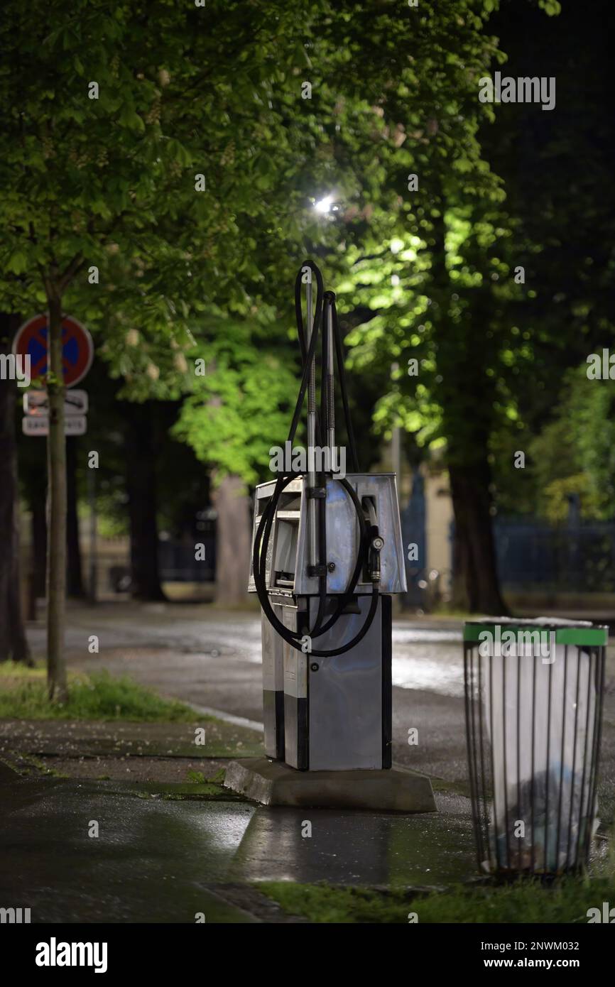 Lonely gas station at night near a waste bin large tree canopies