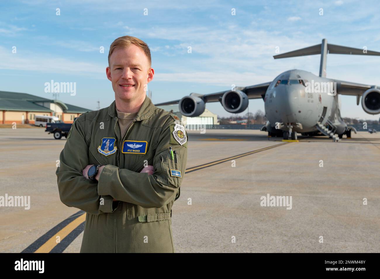 U.S. Air Force Maj. Kyle Wagner, a pilot assigned to the 167th Operations Group, poses for a photo in front of a C-17 Globemaster III aircraft at the 167th Airlift Wing, Martinsburg, West Virginia, Jan. 08, 2023. Wagner recently graduated the U.S. Air Force Weapons School Weapons Instructor Course, becoming the first C-17 Weapons Officer at the 167th. Stock Photo