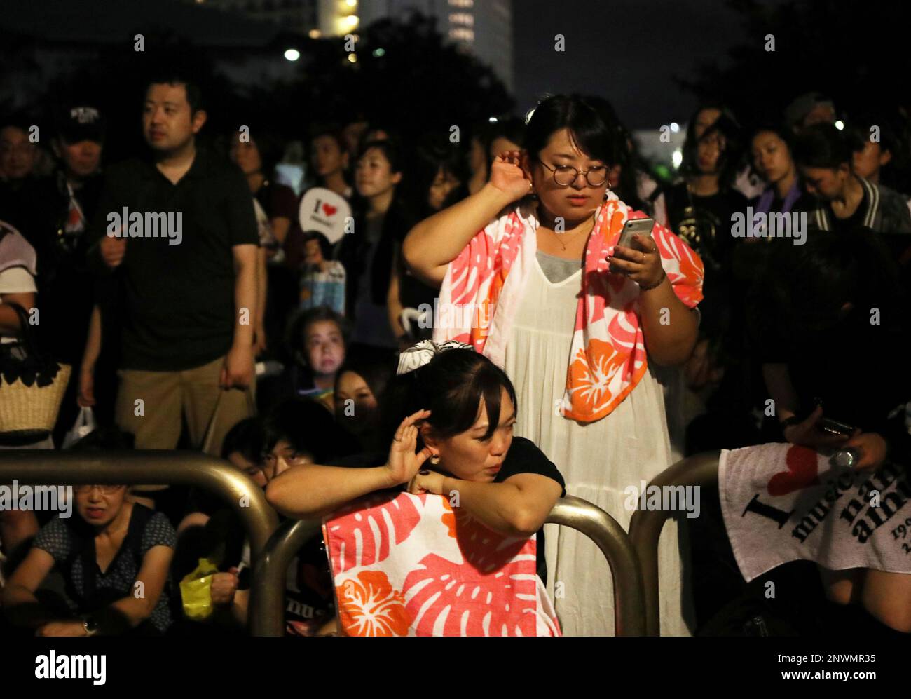 Fans of Namie Amuro try to listen to the sound coming out from the 