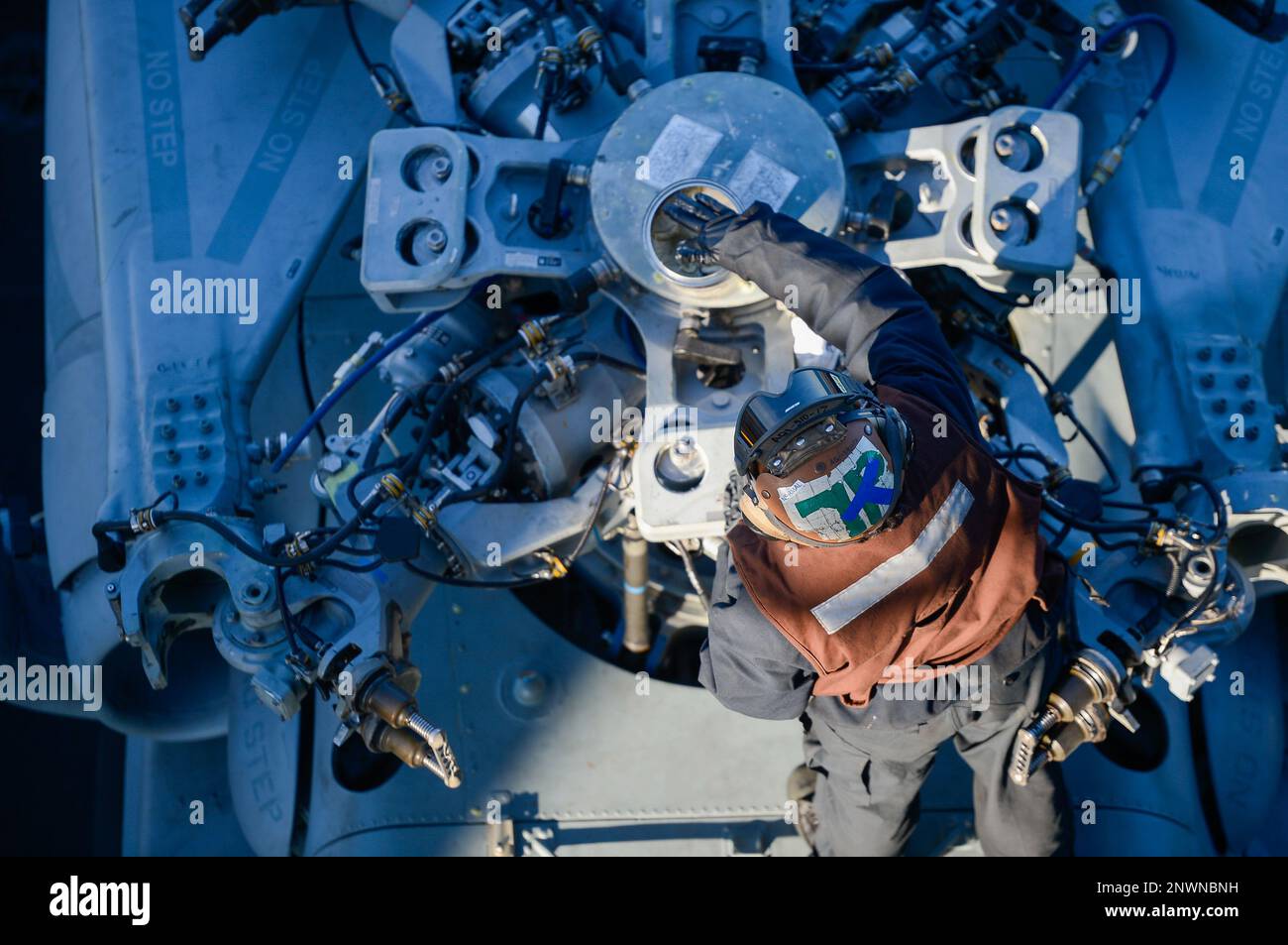 230128-N-OB471-1015 ATLANTIC OCEAN (Jan. 28, 2023) Aviation Machinist's Mate Airman Daniela Garcia, from Aguascalientes, Mexico, cleans and lubricates the bifilar of an MH-60S Sea Hawk helicopter, attached to the 'Dusty Dogs' of Helicopter Sea Combat Squadron (HSC) 7, on the flight deck aboard the Nimitz-class aircraft carrier USS Dwight D. Eisenhower (CVN 69). IKE is underway conducting ammunition onload, flight deck certification and air wing qualification as part of its tailored basic phase prior to deployment. Stock Photo