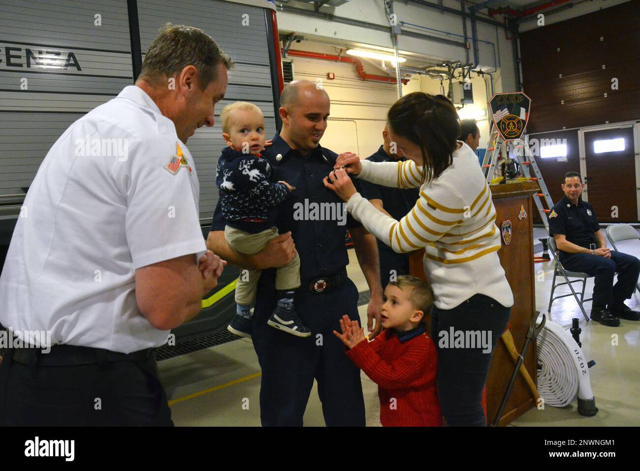 VICENZA, Italy – U.S. Army Garrison Italy Firefighter Davide Miozzo is presented his badge during the pinning ceremony at the Fire Station on Caserma Del Din Jan. 12, 2023.  At the event, three Italian firefighters were presented their badges after completing their courses in Vicenza, and travelling to Ansbach, Germany for the final testing and evaluations, all in English. The USAG Italy Fire Department will conduct a training academy each year to continue to provide trained and qualified firefighters across the garrison in support of the people who live and work on the installations. Stock Photo