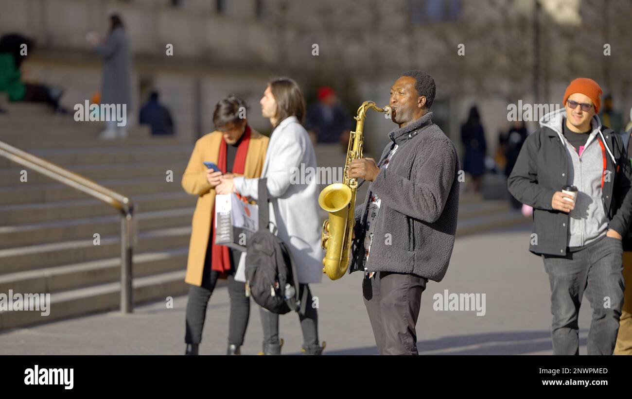 Saxophone player busking in the streets of New York street