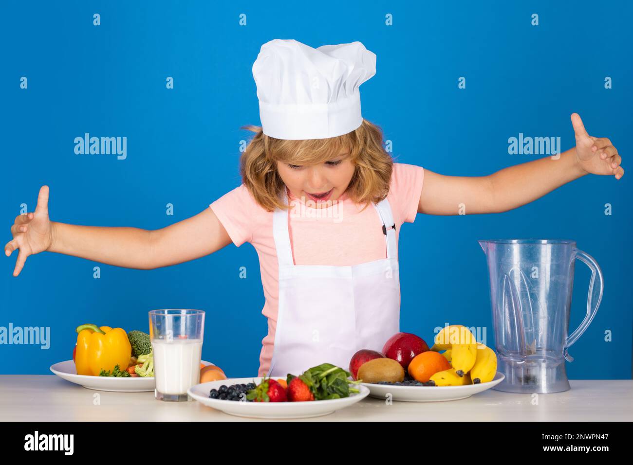 Cooking children. Fruits and vegetables for kids. Chef kid boy making