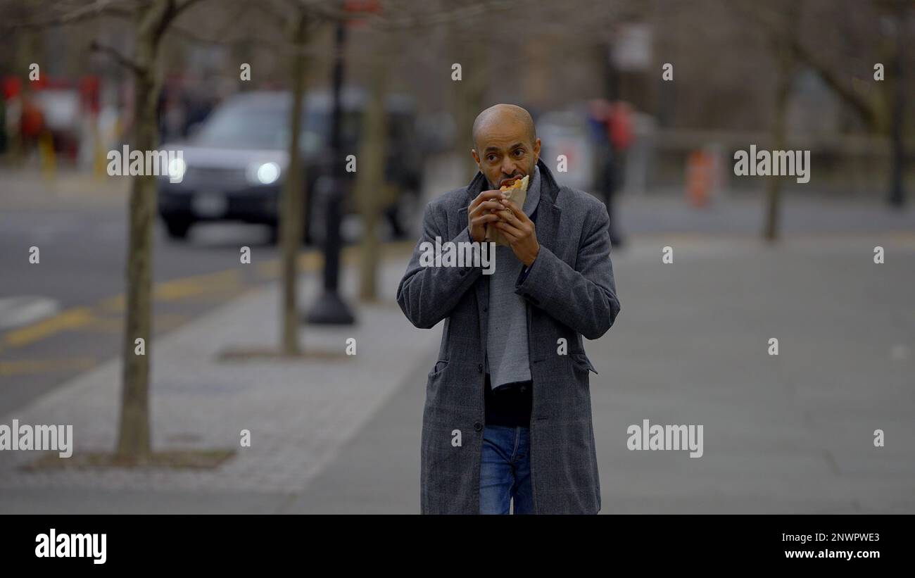 Eating a hot dog in the streets of New York street photography Stock