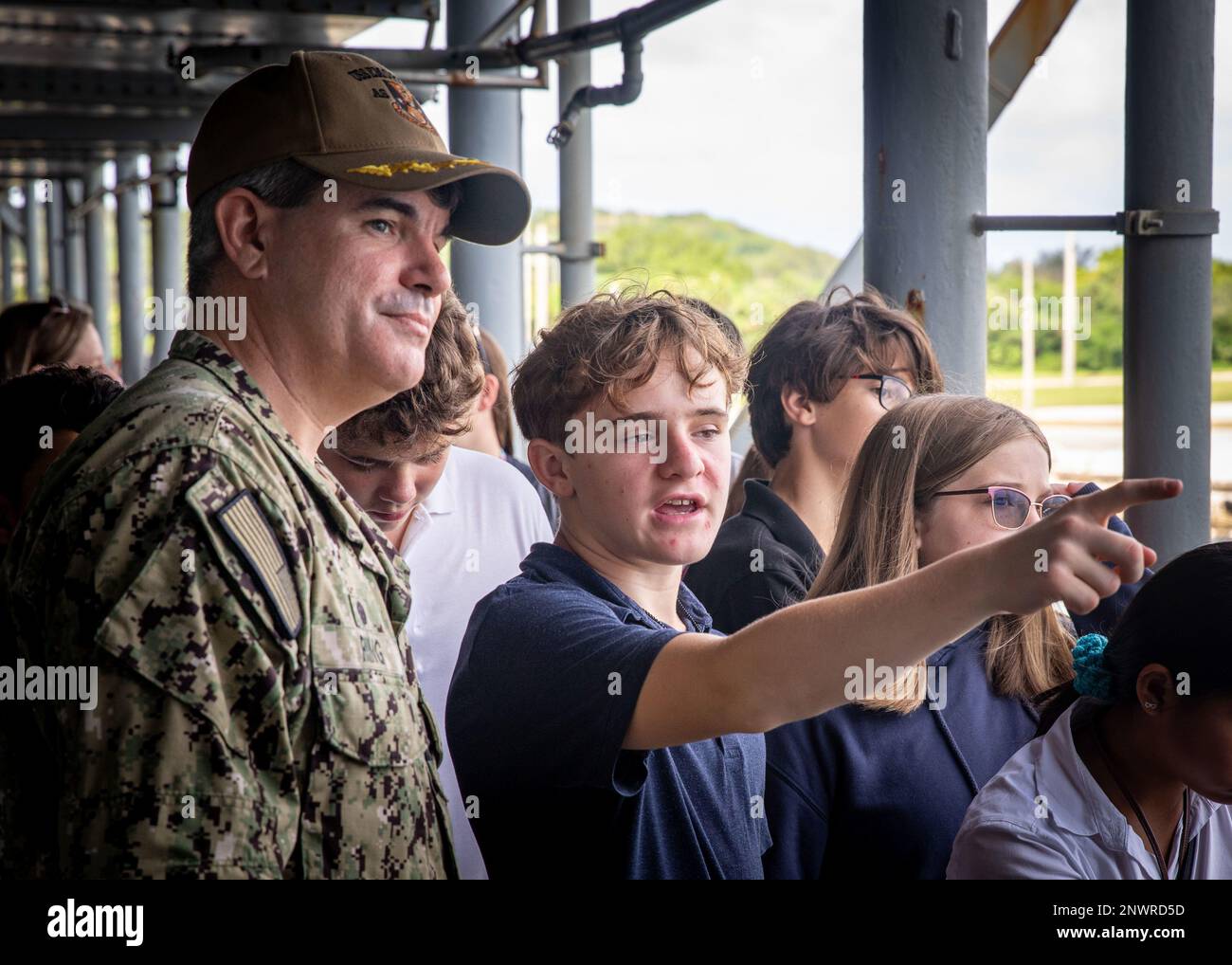 APRA HARBOR, Guam (Jan. 12, 2023)—Capt. Andrew H. Ring, commanding officer of the submarine tender USS Emory S. Land (AS 39), answers questions from students from Cmdr. William C. McCool Middle School, during a tour aboard the ship, Jan. 12. Emory S. Land is tasked to provide expeditionary intermediate level maintenance and repairs, as well as provide hotel services and logistics support to deployed guided-missile and fast-attack submarines. Stock Photo