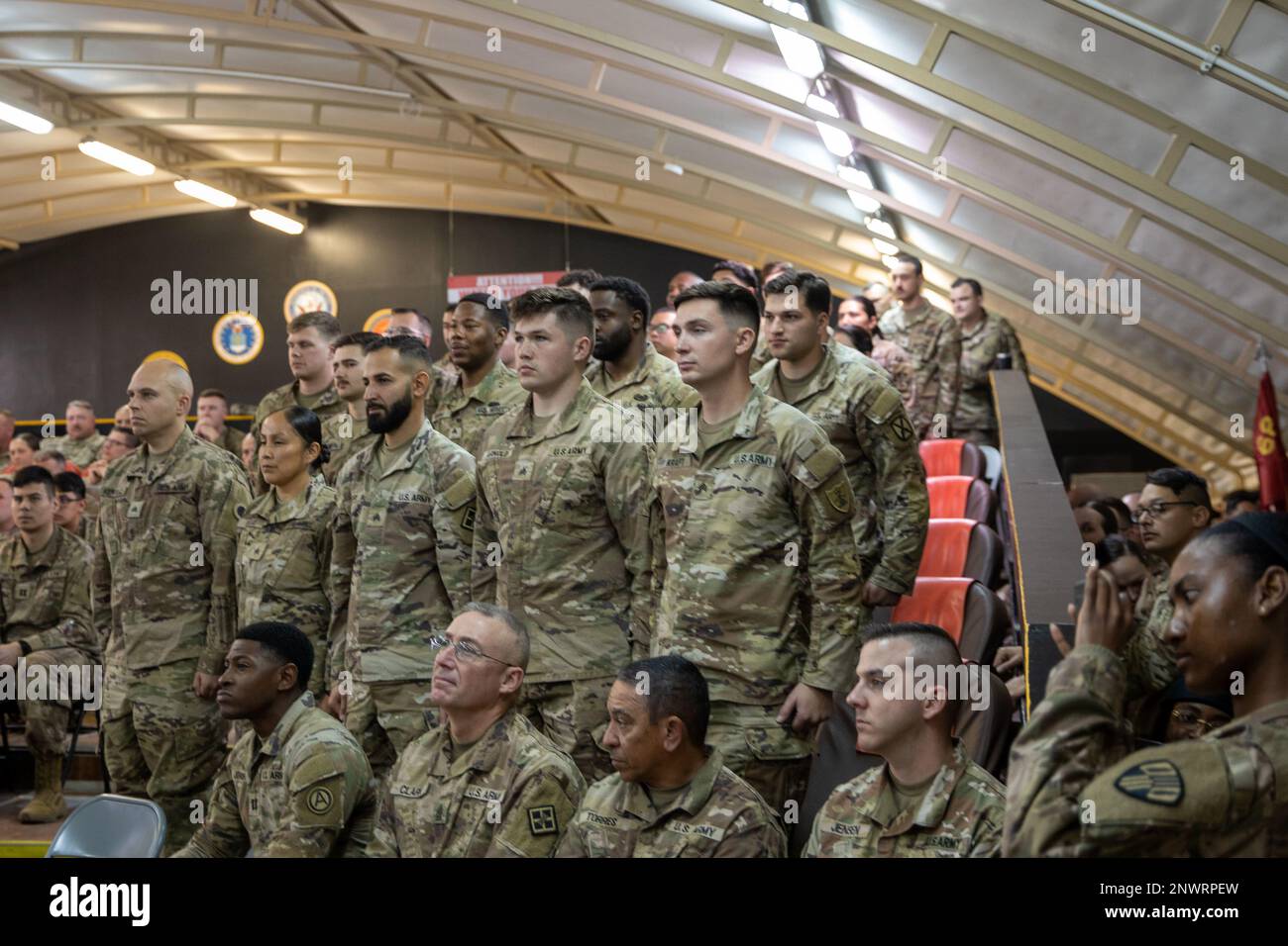 U.S. Army Soldiers who completed their Basic Leader Course (BLC) stand and receive recognition during a BLC graduation ceremony held in a theatre tent on Camp Buehring, Kuwait, Jan. 25, 2023. Stock Photo