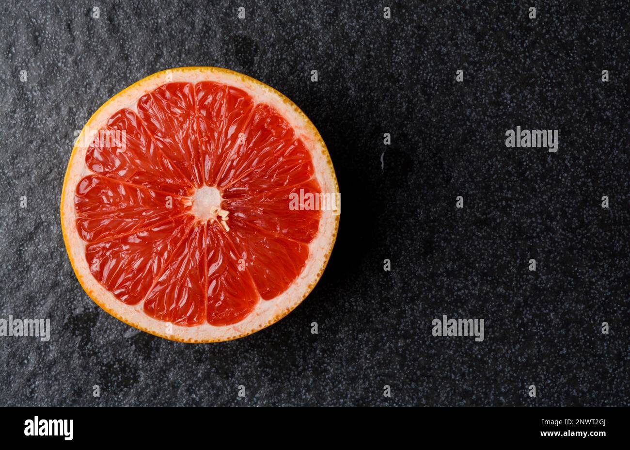 Closeup view of grapefruit on a red background Stock Photo