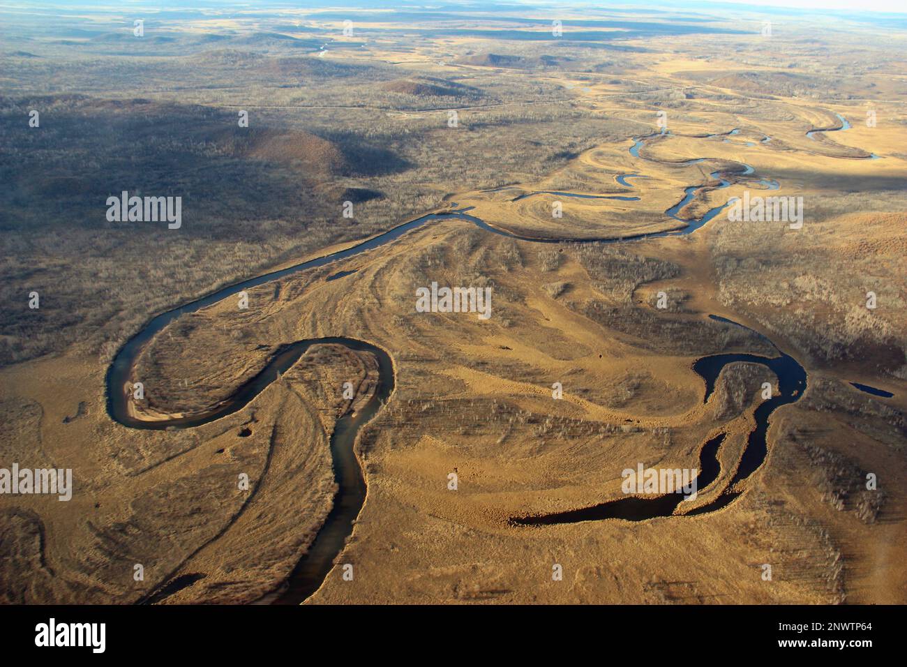 (FILE) Aerial photo taken on Oct 20, 2015 shows meandering rivers and golden forests in Greater Khingan Range wetland in Northeast China's Heilongjian Stock Photo