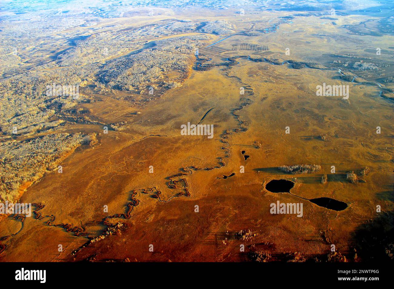 (FILE) Aerial photo taken on Oct 20, 2015 shows meandering rivers and golden forests in Greater Khingan Range wetland in Northeast China's Heilongjian Stock Photo
