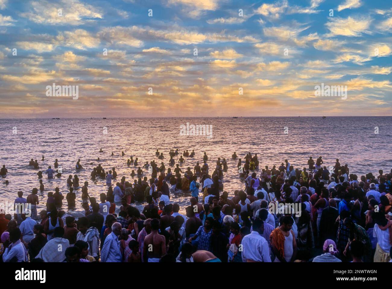 Devotees taking a dip in the holy waters of the Agni Theertham in Rameswaram, Tamil Nadu, South India, India, Asia. Bay of Bengal. Sunrise Stock Photo
