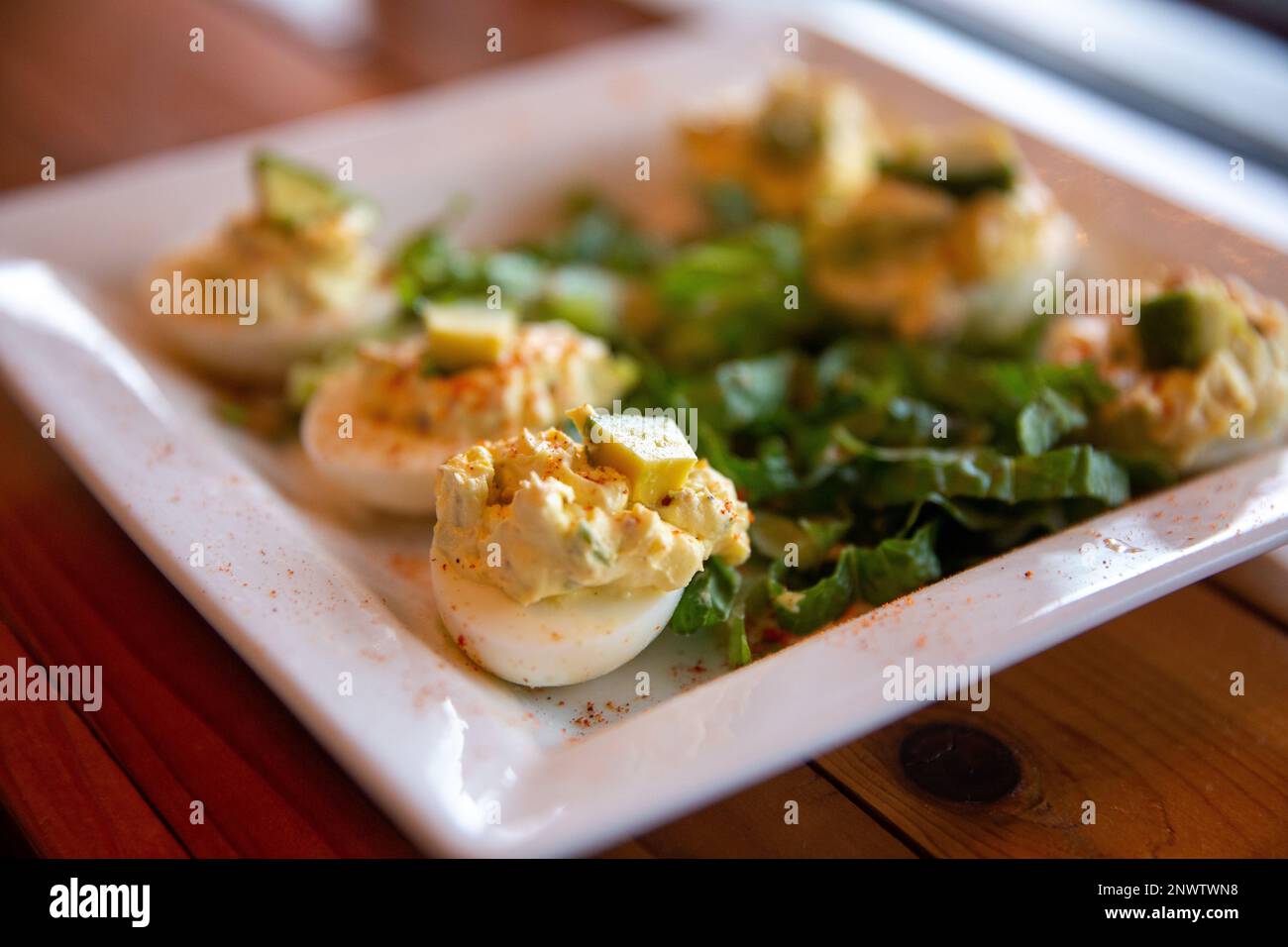 Deviled Eggs topped with avocado Stock Photo