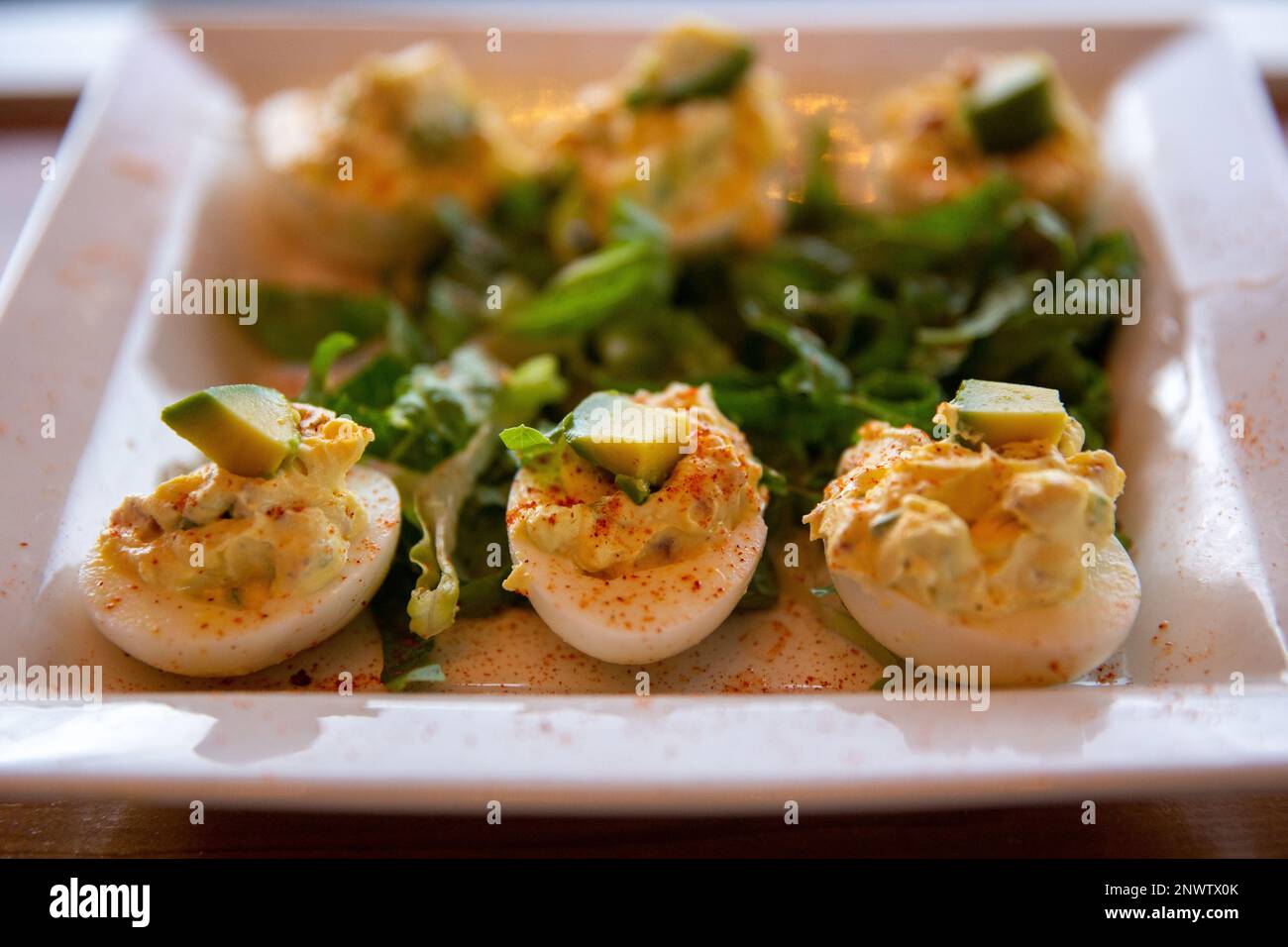 Deviled Eggs topped with avocado Stock Photo