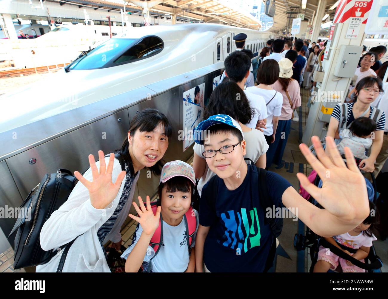 People wait for a bullet train, Shinkansen line at JR Tokyo Station in  Tokyo, Japan on Aug. 11, 2018, as Bon holidays start. Families return to  their hometown to pray for their