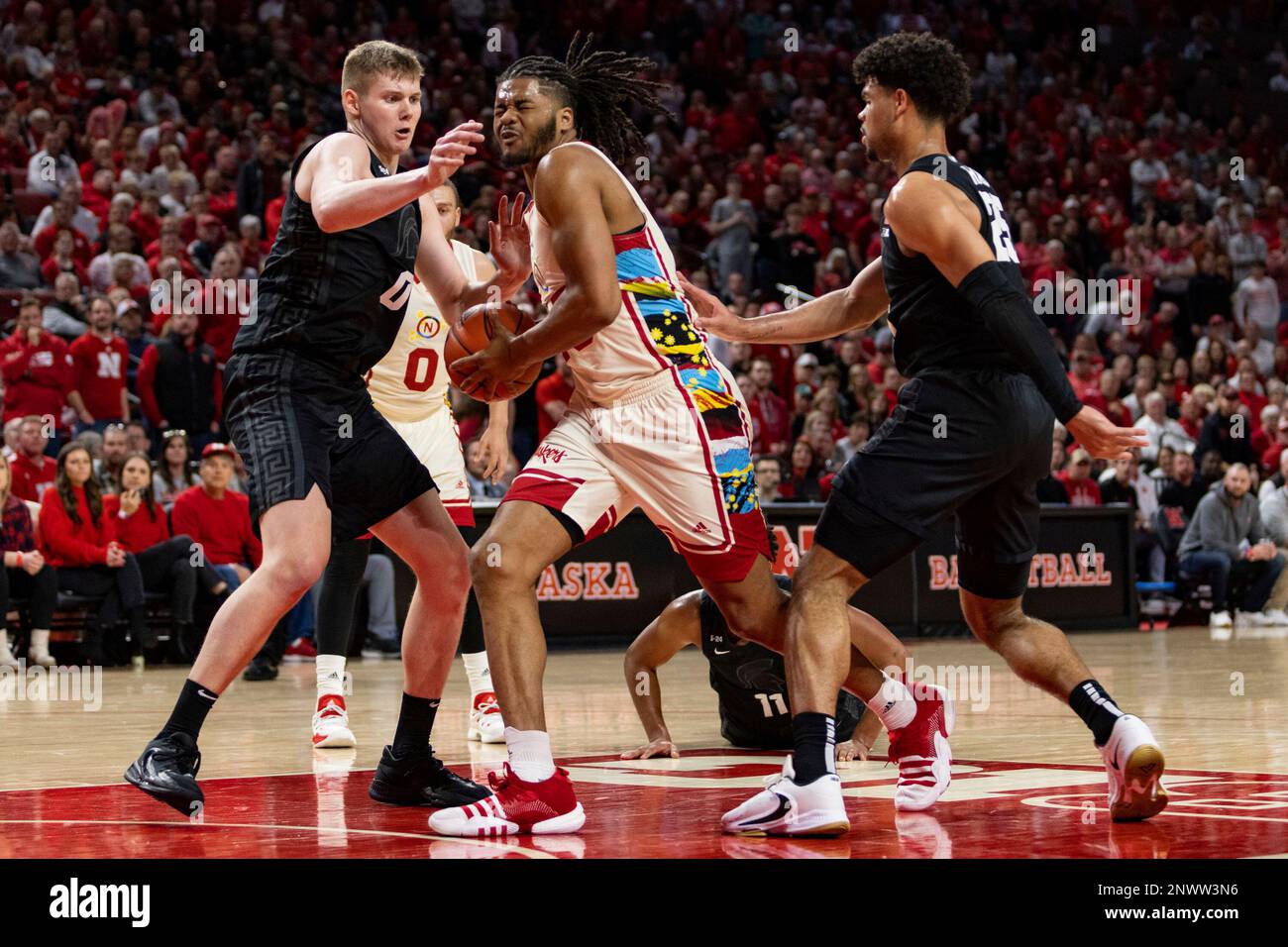 Nebraska's Derrick Walker (13) drives to the basket against Michigan