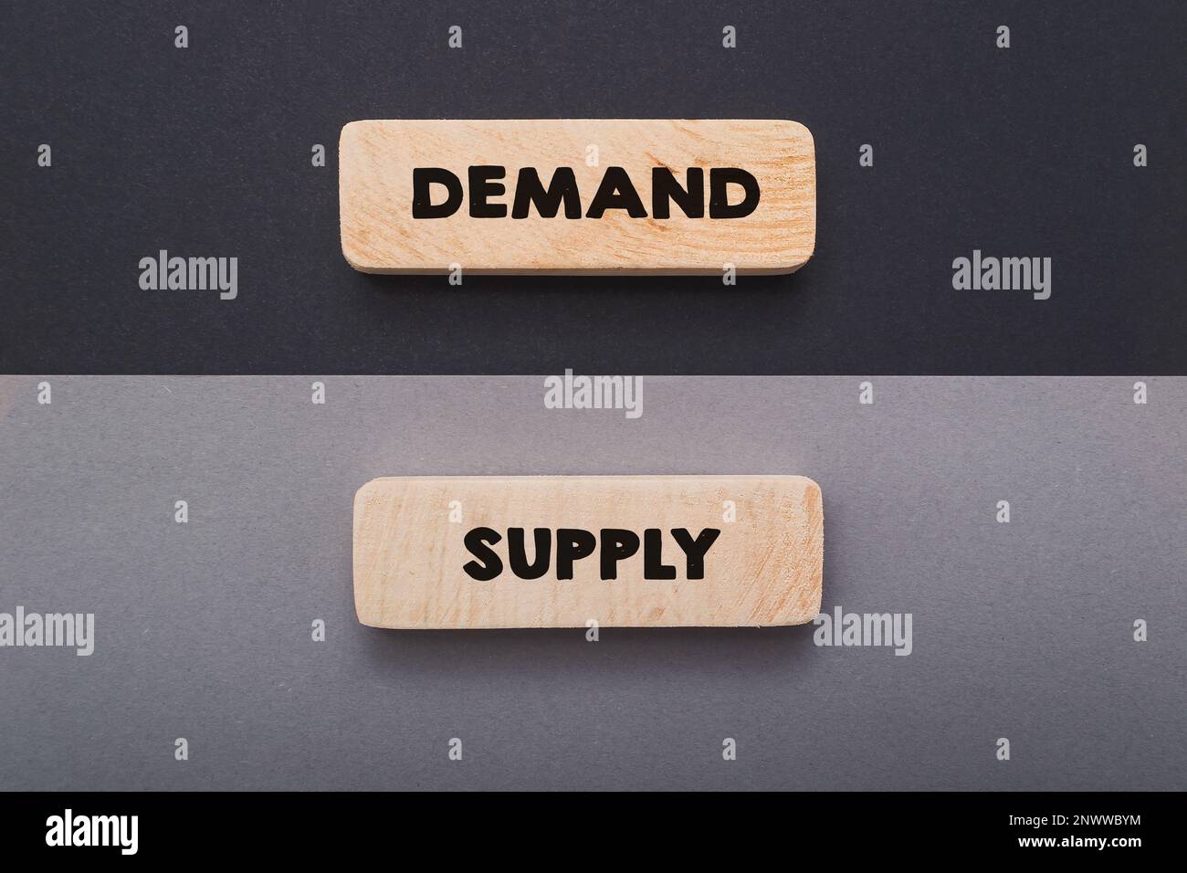 Tablets with words Demand and Supply on greyish backgrounds Stock Photo