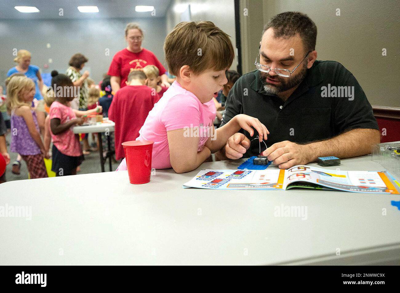 Crissa Watson, left, and her father David assemble a circuit board